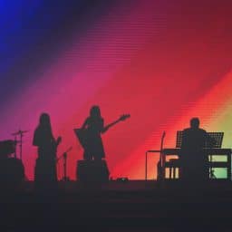 Band playing a live show on stage.