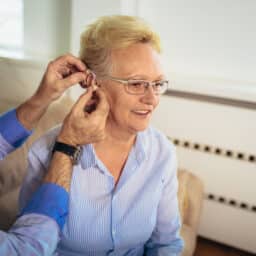Woman is fitted for hearing aid