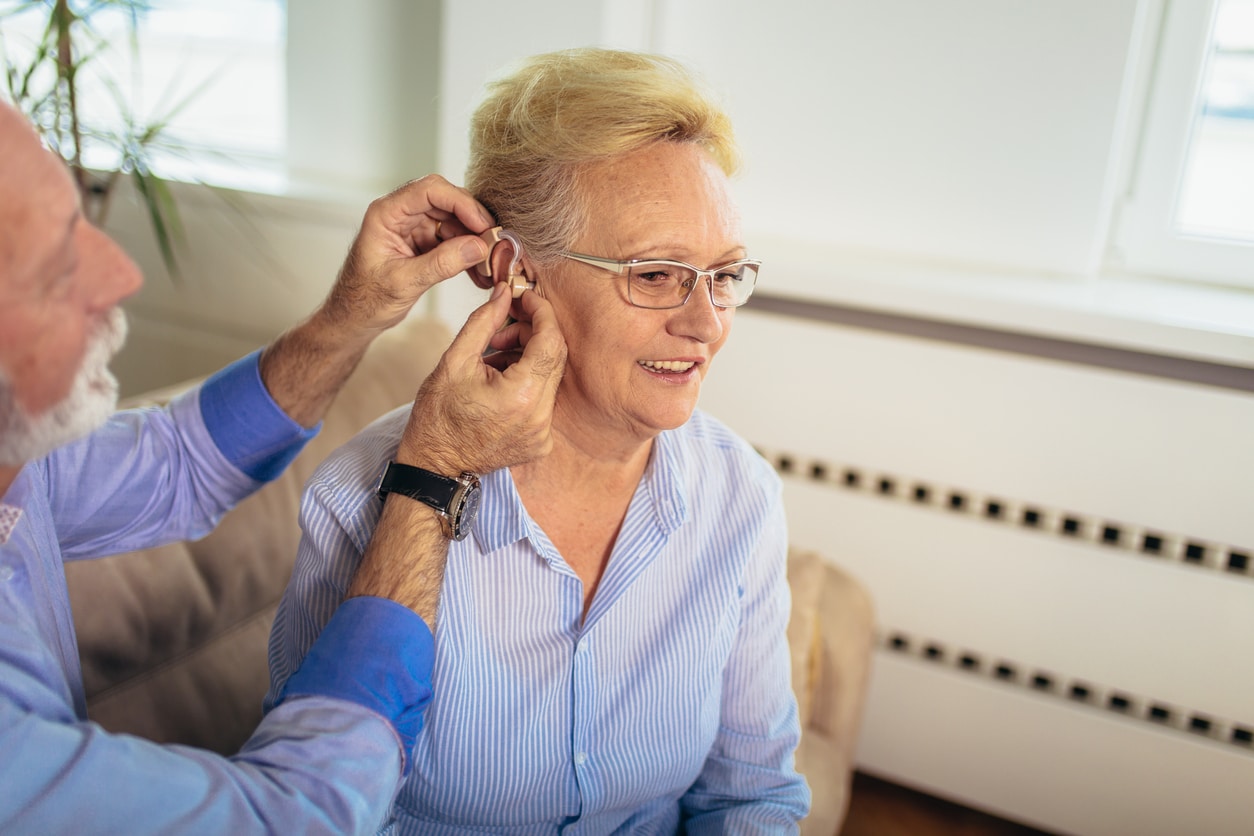 Woman is fitted for hearing aid