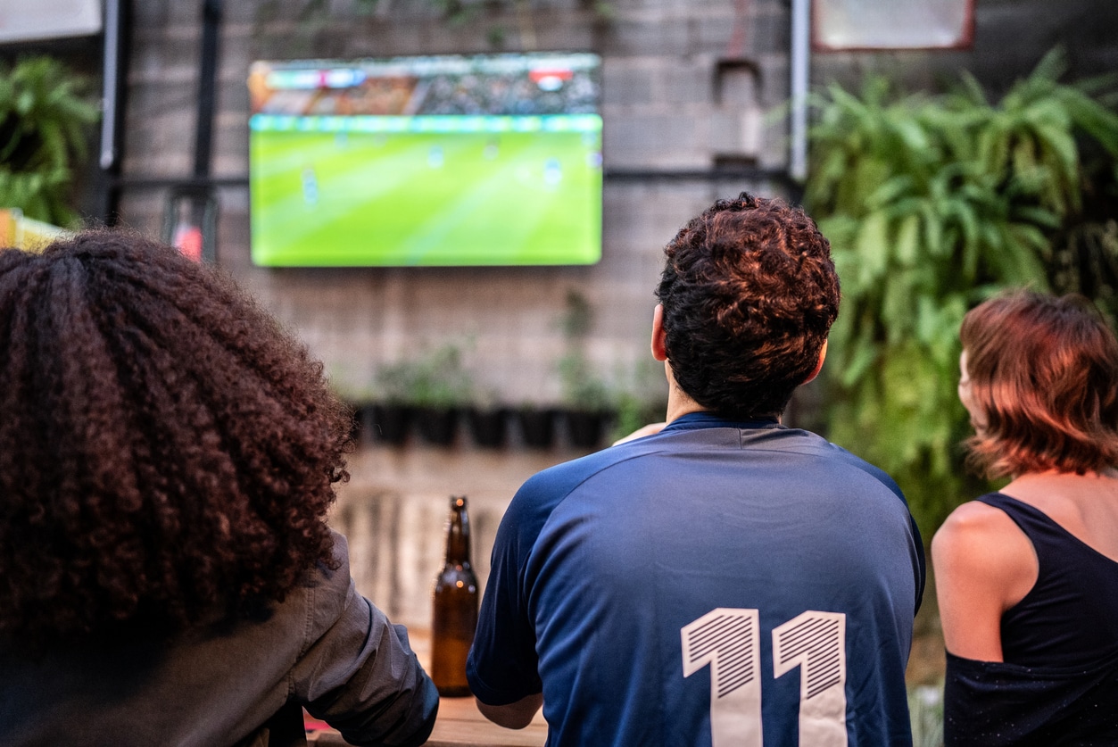 Friends watch football game together