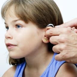 Young girl getting a new hearing aid