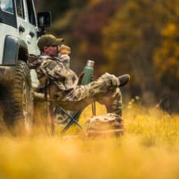 Hunter Seating Next to His All Wheel Drive Vehicle and Drinking Coffee